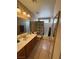 Well-lit bathroom featuring a vanity with a sink, mirror, and a shower with a patterned curtain at 5517 Rock Creek Ln, Las Vegas, NV 89130