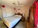 A bedroom showcasing a comfortable bed, ceiling fan, and dresser at 5517 Rock Creek Ln, Las Vegas, NV 89130