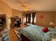 Spacious bedroom with a cozy bed, a ceiling fan, a desk and wood floors at 5517 Rock Creek Ln, Las Vegas, NV 89130
