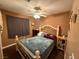 Comfortable bedroom with a decorative bed, ceiling fan, and warm-toned walls at 5517 Rock Creek Ln, Las Vegas, NV 89130