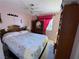 A bedroom featuring a large bed and light pink walls with decorative furniture at 5517 Rock Creek Ln, Las Vegas, NV 89130