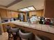 Spacious kitchen featuring a breakfast bar with seating and traditional wooden cabinetry at 5517 Rock Creek Ln, Las Vegas, NV 89130