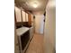 Functional laundry room with modern washer and dryer units, storage cabinets, and tile flooring at 5517 Rock Creek Ln, Las Vegas, NV 89130