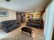 Open-concept living room with tile floors showcasing sofas and a glimpse of the kitchen at 5517 Rock Creek Ln, Las Vegas, NV 89130