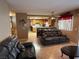 Inviting living room flowing into the kitchen area with cozy seating and tile flooring at 5517 Rock Creek Ln, Las Vegas, NV 89130