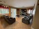 Inviting living room featuring tile floors and comfortable recliner seating with large media center at 5517 Rock Creek Ln, Las Vegas, NV 89130