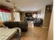 Comfortable living room with tile flooring, a ceiling fan, and a large entertainment center at 5517 Rock Creek Ln, Las Vegas, NV 89130