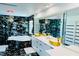 Modern bathroom features black marble accents, a soaking tub, sleek vanities, and stylish gold fixtures at 5568 Yellow Ash St, Las Vegas, NV 89118