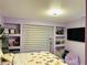 Charming bedroom with built-in shelving, a full window and a butterfly themed bedspread at 5568 Yellow Ash St, Las Vegas, NV 89118