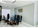 A dining room with a marble floor, an elegant table with chairs, and a decorative painting on the wall at 5568 Yellow Ash St, Las Vegas, NV 89118