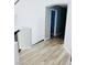 A bright hallway featuring a hardwood floor and arched doorway, creating a clean and inviting space at 5568 Yellow Ash St, Las Vegas, NV 89118