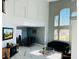 Open concept living room with high ceilings, large windows, and modern decor at 5568 Yellow Ash St, Las Vegas, NV 89118