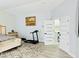 An airy main bedroom features a bed and workout equipment, complemented by light-toned flooring and artful decor at 5568 Yellow Ash St, Las Vegas, NV 89118