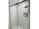 Walk-in shower with clear glass door, black hardware, niche and rain-drop like tile accents at 5568 Yellow Ash St, Las Vegas, NV 89118
