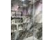 Walk-in shower showcasing sleek fixtures, built-in shelving, and gray marble-look tiles at 5568 Yellow Ash St, Las Vegas, NV 89118