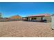 Expansive backyard featuring rock landscaping, block wall, and covered patio at 5730 Coleman St, North Las Vegas, NV 89031