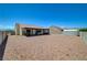 Large backyard features rock landscaping, patio, storage, and mountain views in distance at 5730 Coleman St, North Las Vegas, NV 89031