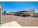 Extensive backyard view features a patio, rock landscaping, storage shed, and block wall at 5730 Coleman St, North Las Vegas, NV 89031