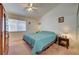 Cozy bedroom featuring a comfortable bed, ceiling fan, and a window with natural light at 5730 Coleman St, North Las Vegas, NV 89031