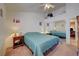 Bedroom featuring a bed, ceiling fan, mirrored closet, and neutral walls at 5730 Coleman St, North Las Vegas, NV 89031