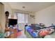 Bedroom featuring a bed, TV, and window with natural light at 5730 Coleman St, North Las Vegas, NV 89031