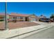 Street view of single story home with low maintenance rock yard and long driveway at 5730 Coleman St, North Las Vegas, NV 89031