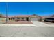 Single story home with neutral colors, a well-kept rock yard, and a two car garage at 5730 Coleman St, North Las Vegas, NV 89031