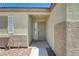 Inviting front door entrance with a security screen door and neutral stucco at 5730 Coleman St, North Las Vegas, NV 89031