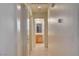 Hallway showing access to a bathroom with a vanity and good lighting at 5730 Coleman St, North Las Vegas, NV 89031