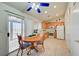 Bright kitchen with wooden cabinets, white appliances, and a cozy dining area at 5730 Coleman St, North Las Vegas, NV 89031