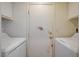 Functional laundry room with a door, washer, and dryer at 5730 Coleman St, North Las Vegas, NV 89031