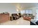 Spacious living room featuring tile flooring, a ceiling fan, and backyard access at 5730 Coleman St, North Las Vegas, NV 89031