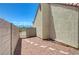 Side yard features rock landscaping and concrete pavers leading to access gate at 5730 Coleman St, North Las Vegas, NV 89031