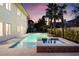 Backyard oasis with a large swimming pool, hot tub, palm trees, and beautiful landscaping at 605 Canyon Greens Drive Dr, Las Vegas, NV 89144
