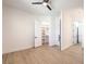This bedroom features wood-look floors, a ceiling fan, and a walk-in closet at 605 Canyon Greens Drive Dr, Las Vegas, NV 89144