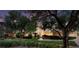 Beautifully landscaped front yard with mature trees and manicured bushes creates great curb appeal at 605 Canyon Greens Drive Dr, Las Vegas, NV 89144