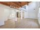 Spacious living room with wood-look floors, high ceilings, and a modern chandelier, perfect for gatherings at 605 Canyon Greens Drive Dr, Las Vegas, NV 89144