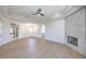 Spacious living room features fireplace, tray ceiling, fan, and access to multiple rooms at 605 Canyon Greens Drive Dr, Las Vegas, NV 89144