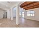 Bright living room with wood-look floors, white columns, and a view to the backyard, creating a seamless flow at 605 Canyon Greens Drive Dr, Las Vegas, NV 89144