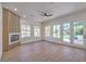 Bright living room featuring a modern fireplace, recessed lighting, and backyard access through glass doors at 605 Canyon Greens Drive Dr, Las Vegas, NV 89144