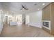 Spacious living room with kitchen view, fireplace, and staircase access creating an inviting atmosphere at 605 Canyon Greens Drive Dr, Las Vegas, NV 89144