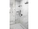 Luxurious shower featuring marble tiling, rainfall showerhead, and modern fixtures at 605 Canyon Greens Drive Dr, Las Vegas, NV 89144