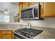Updated kitchen with stainless appliances, granite counters, and a modern microwave at 698 S Racetrack Rd # 1714, Henderson, NV 89015