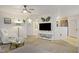 Bright living room with neutral carpet, ceiling fan and a view into the kitchen at 698 S Racetrack Rd # 1714, Henderson, NV 89015