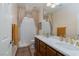 Bathroom with a double sink vanity, framed mirror, marble countertop, and decorative curtains at 7126 Mirkwood Ave, Las Vegas, NV 89178