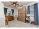 Charming bedroom featuring blue curtains, a wooden armoire, and neutral decor at 7126 Mirkwood Ave, Las Vegas, NV 89178