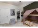 Spacious bedroom features a custom canopy bed, walk-in closet, and modern gray chair at 7126 Mirkwood Ave, Las Vegas, NV 89178