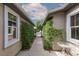 Charming courtyard entrance with lush greenery, decorative accents, and inviting walkway at 7126 Mirkwood Ave, Las Vegas, NV 89178