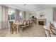 Sunlit dining room with large windows, stylish decor, and open flow to kitchen area at 7126 Mirkwood Ave, Las Vegas, NV 89178