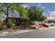 Charming single-story home featuring mature landscaping, brick accents and a vibrant red vintage car at 7126 Mirkwood Ave, Las Vegas, NV 89178